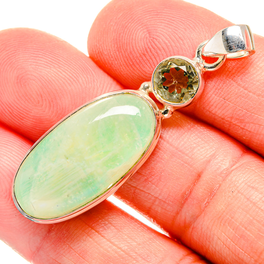 Green oval gemstone pendant with round green top stone, silver-tone bail