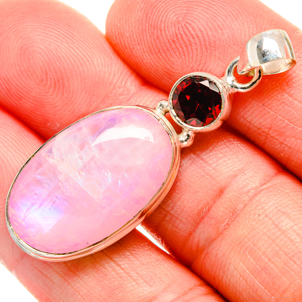Oval pink moonstone pendant with round red garnet accents in 925 silver setting