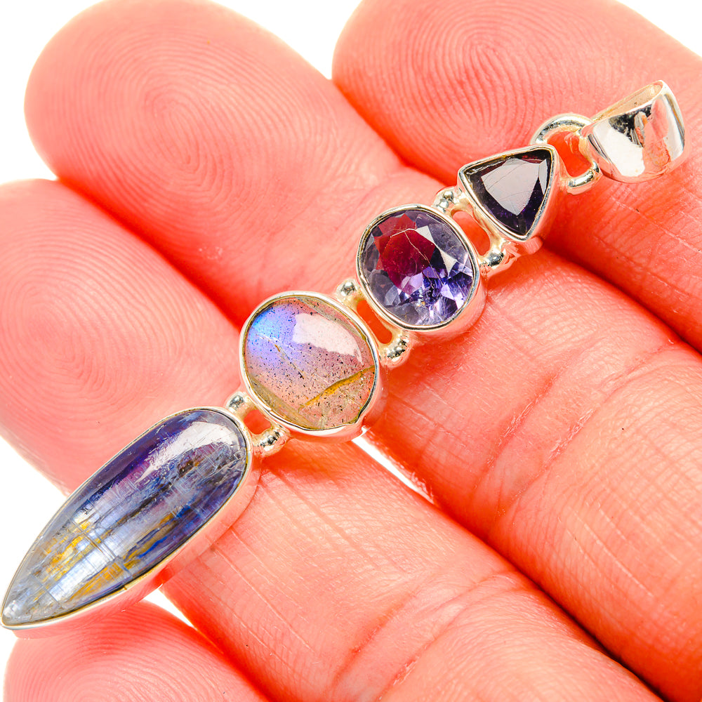 Sterling silver gemstone pendant close-up with blue, yellow, and purple oval settings