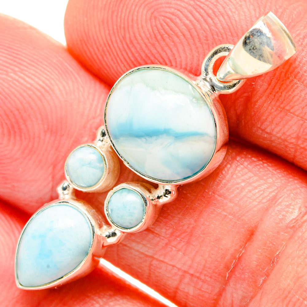 Larimar sterling silver pendant close-up: round center larimar with small blue stones