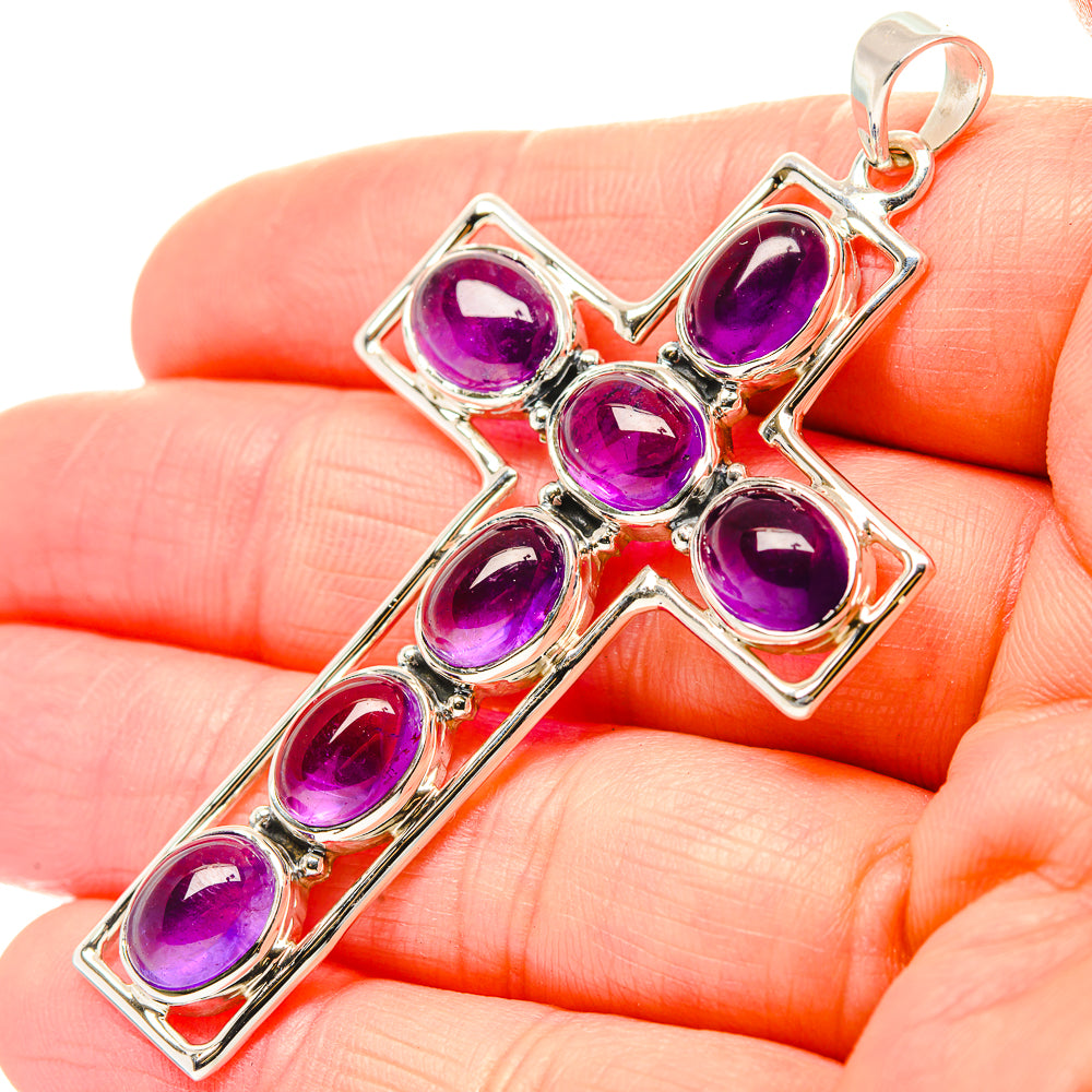 Sterling silver amethyst cross pendant with faceted oval purple stones and hanging loop