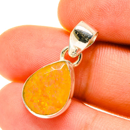 Faceted Ethiopian opal pendant close-up: pear-cut orange-yellow opal in silver bail