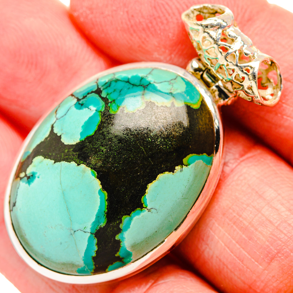 Oval turquoise pendant with black matrix in silver bezel, ornate bail