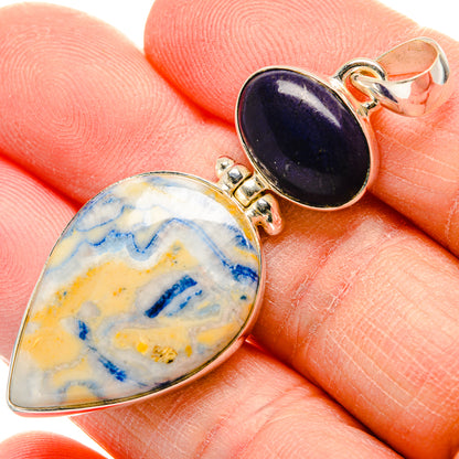 Close-up pear-shaped blue scheelite and black onyx sterling silver pendant