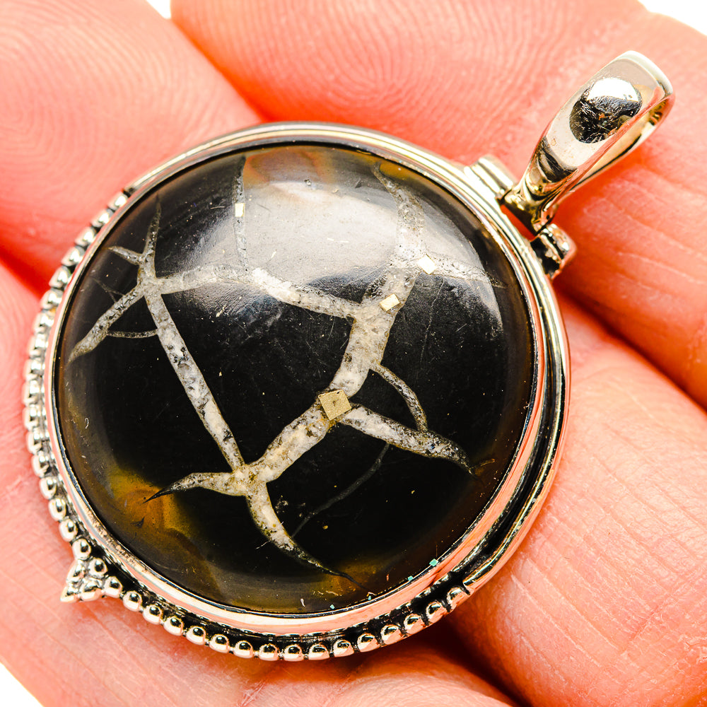 Round black septarian geode pendant, sterling silver bezel with beaded border