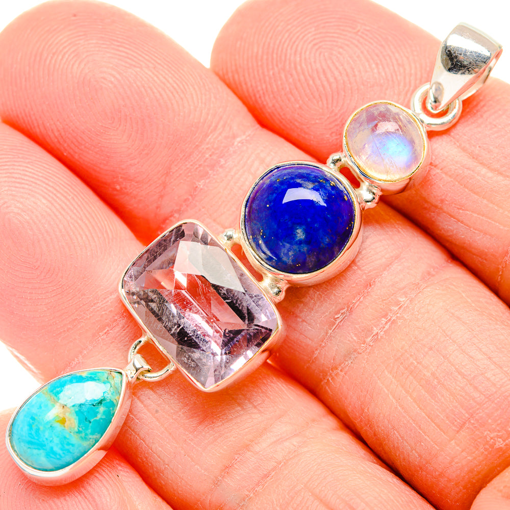 Sterling silver pendant close-up with blue oval, faceted clear stone, and turquoise teardrop