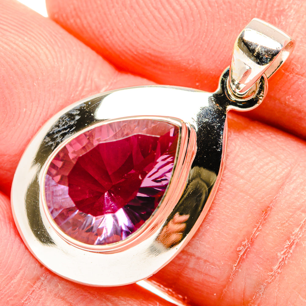 Sterling silver bezel-set oval pendant with pink-red color-change gemstone and loop top
