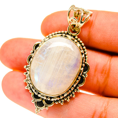 Rainbow moonstone pendant close-up with oval opalescent stone in textured halo bezel