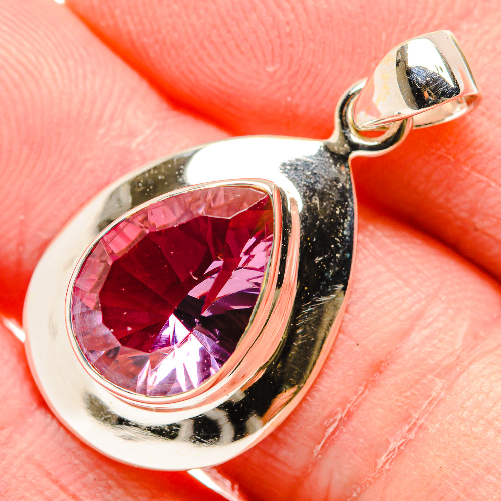 Sterling silver pendant close-up with faceted pink-purple teardrop gemstone
