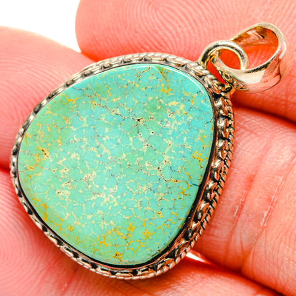 Oval turquoise pendant with textured 925 sterling silver bezel and loop bail