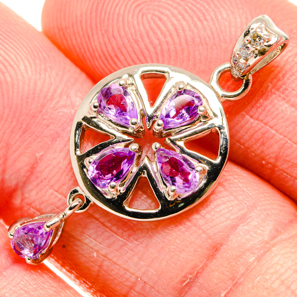 Close-up amethyst pendant charm, sterling silver round setting with 5 purple stones.