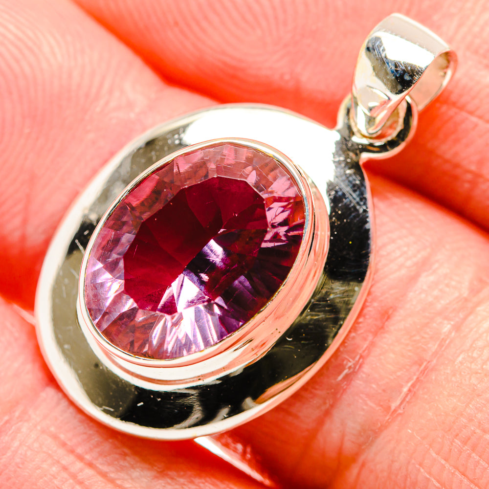 Sterling silver pendant with oval color-change gemstone in pink-red bezel setting