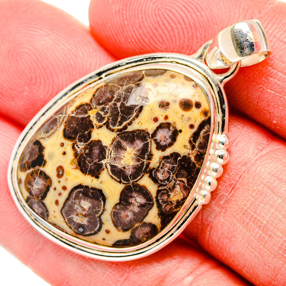 Oval sterling silver Poppy Jasper pendant with textured dark-and-amber stone pattern