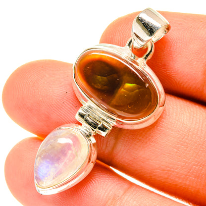 Sterling silver pendant closeup with orange fire agate and light moonstone teardrop