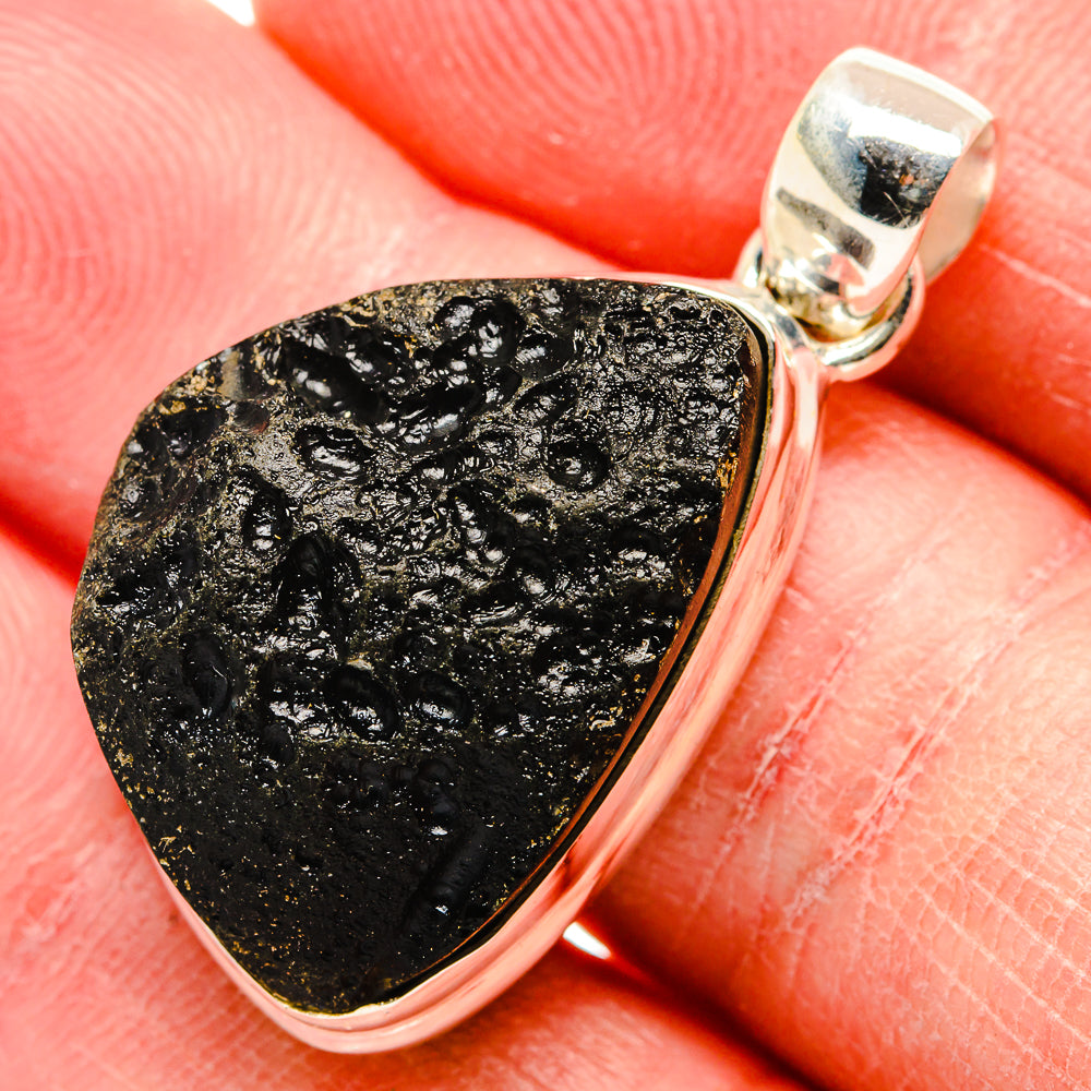 Tektite pendant with black-gold textured stone in polished sterling silver bezel