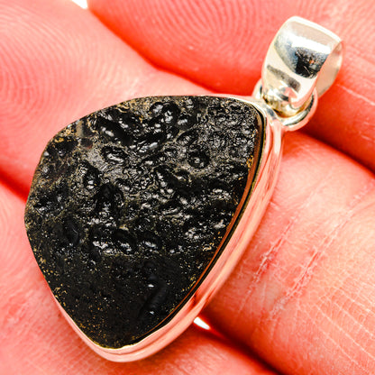 Tektite pendant with black-gold textured stone in polished sterling silver bezel