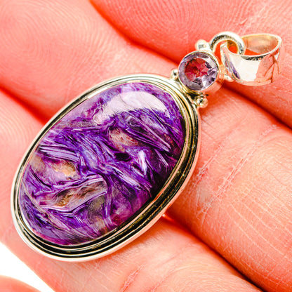 Oval charoite pendant in silver with purple cabochon and small round gemstone bail