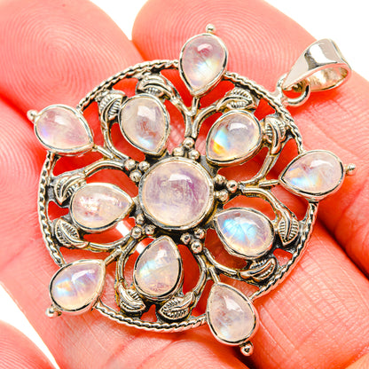 Oval opal-like moonstone pendant with detailed silver filigree and bail