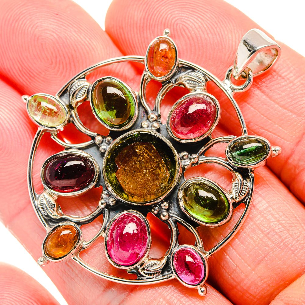 Sterling silver multi-stone pendant with circular setting, bright orange green red gems