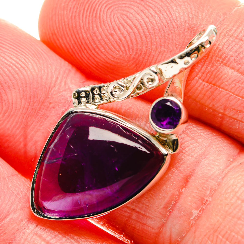 Sterling silver amethyst teardrop pendant with purple cabochon and ornate side settings