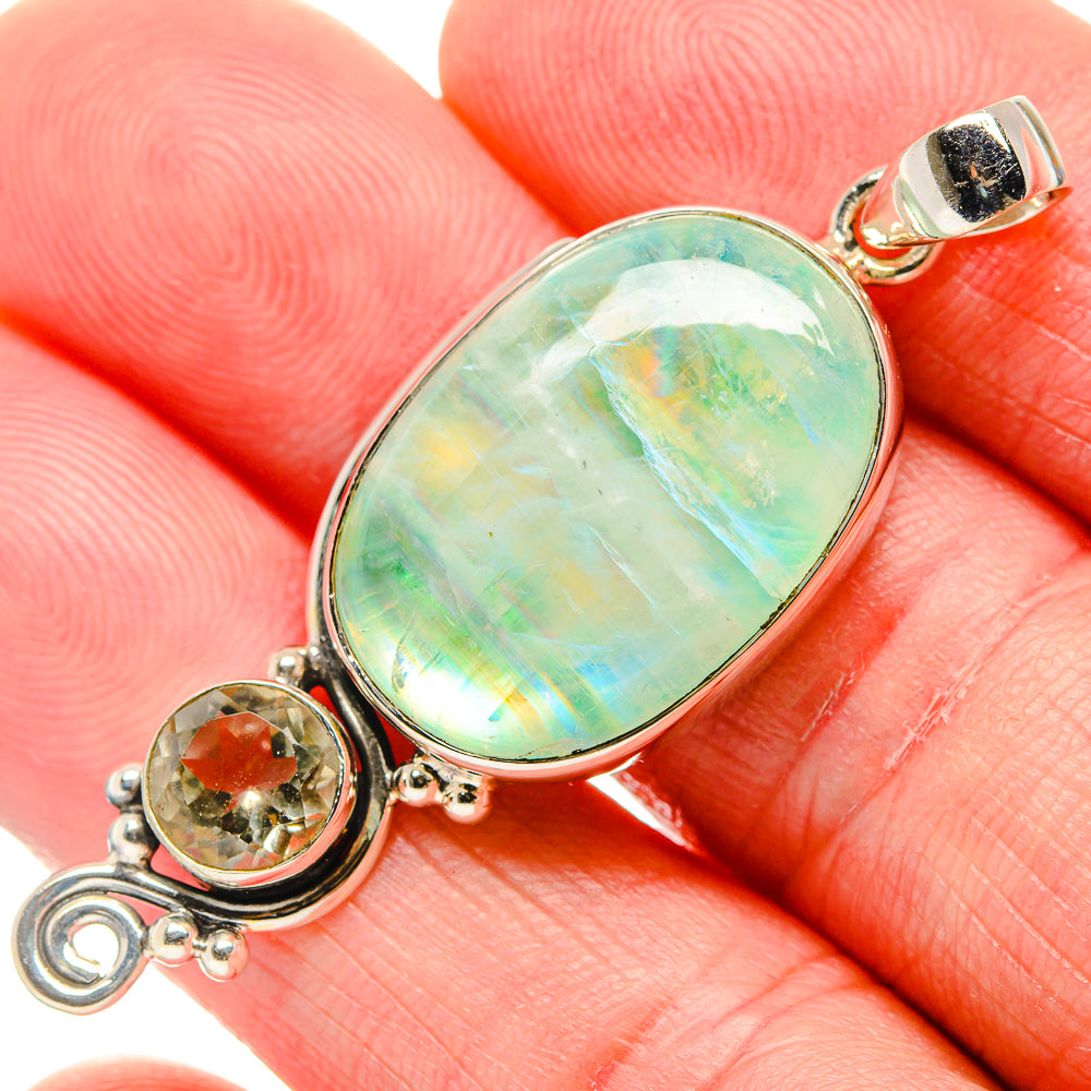 Sterling silver oval green opalescent pendant with round orange accent stone