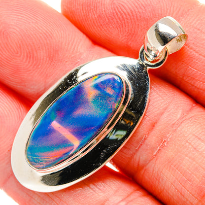 Sterling silver opal pendant with oval bezel and bright blue-purple iridescent center