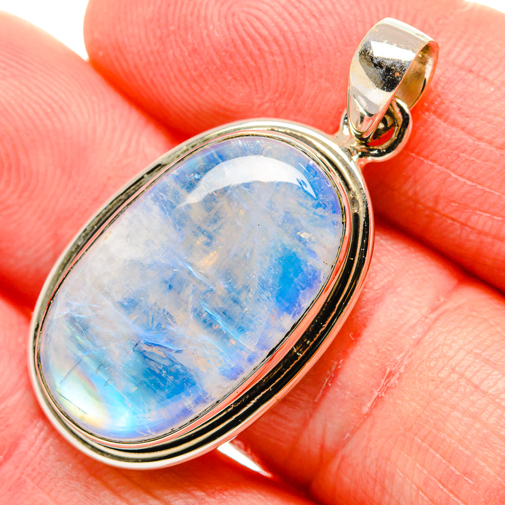 Sterling silver oval moonstone pendant with blue rainbow cabochon and loop bail