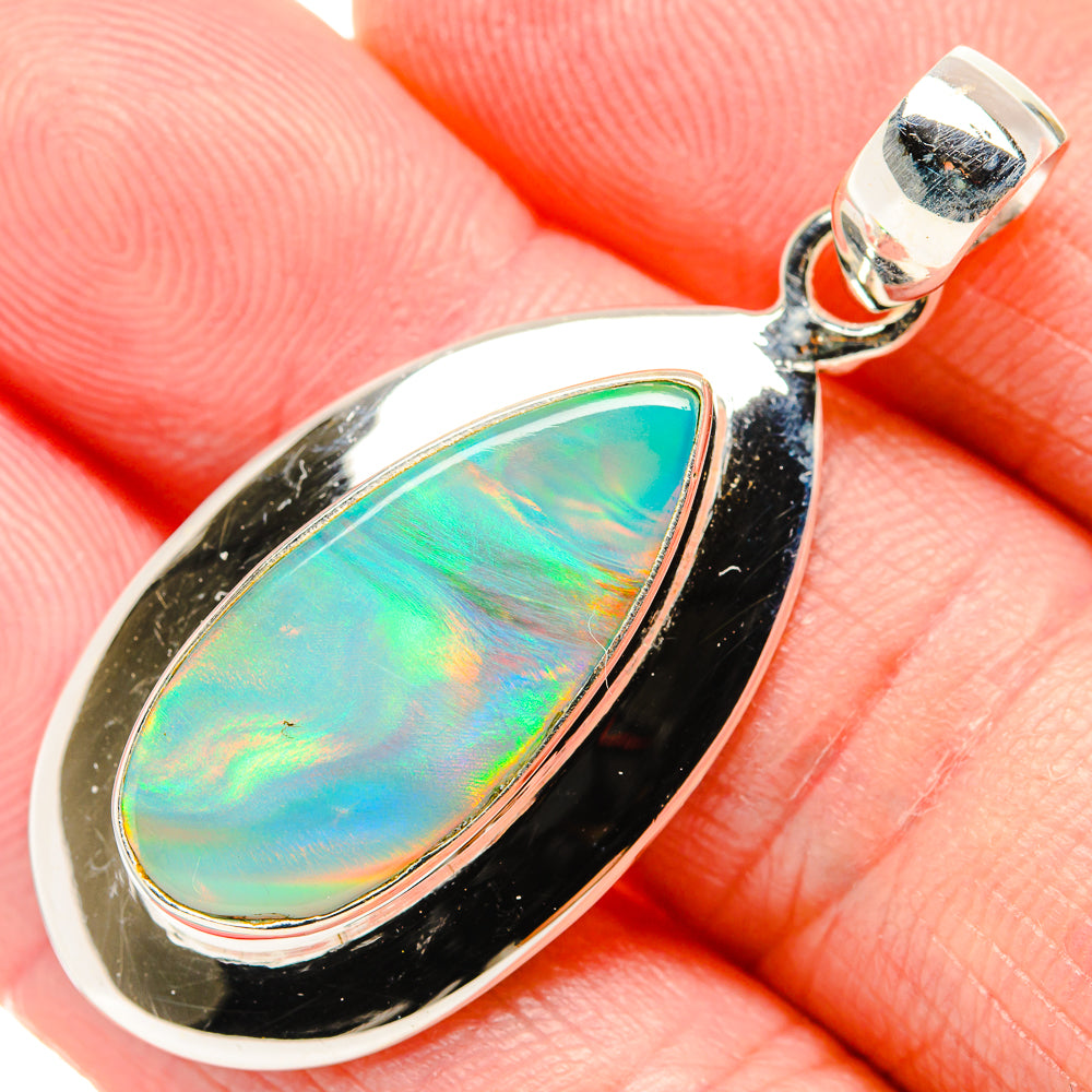 Sterling silver teardrop opal pendant close-up with green-blue iridescent stone and black edge