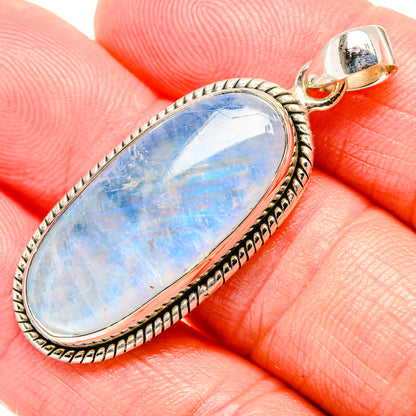 Sterling silver oval rainbow moonstone pendant, textured bezel and gold-toned bail