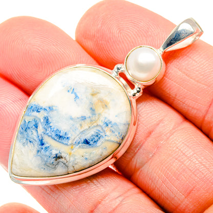 Sterling silver pendant close-up with blue scheelite teardrop stone and cultured pearl