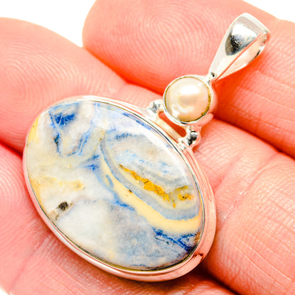 Close-up sterling silver pendant with oval blue scheelite and small round cultured pearl