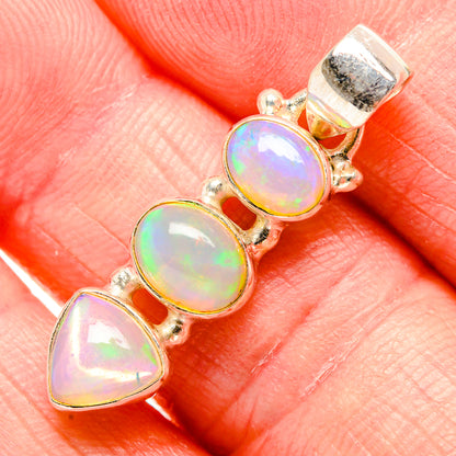 Opal pendant close-up with three gold-tone bezel stones and 925 sterling silver bail