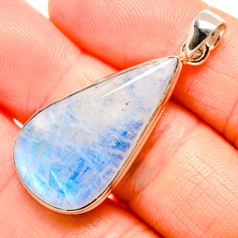 Opalescent teardrop rainbow moonstone pendant in silver-tone bezel, top bail