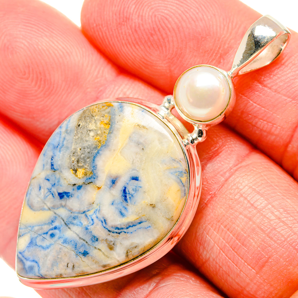 Silver teardrop pendant with blue-pattern stone and pale cultured pearl, close-up
