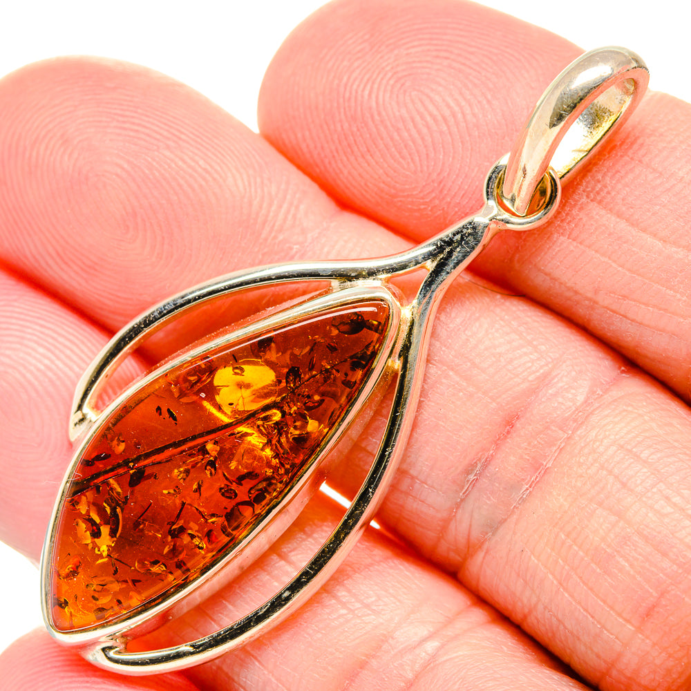 Amber teardrop pendant in 925 silver bezel with gold-toned bail detail