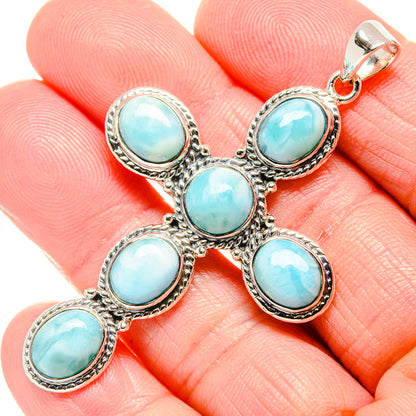 Oval stone cross pendant in sterling silver, five blue Larimar cabochons, closeup