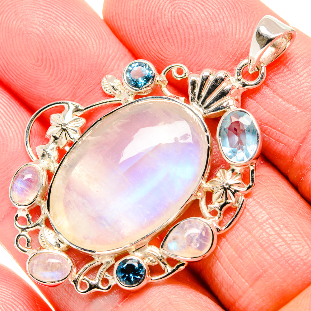 Sterling silver moonstone pendant with blue topaz and rainbow opal center