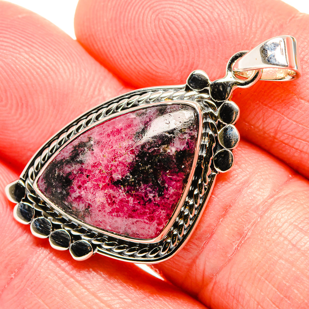 Rhodonite teardrop pendant in 925 sterling silver with ornate bezel and bail