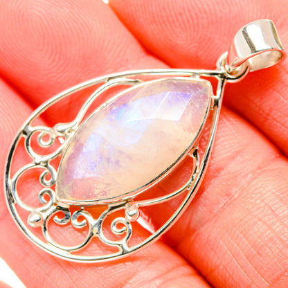 Sterling silver moonstone teardrop pendant with rainbow iridescence and ornate scroll setting