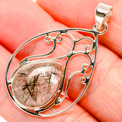 Sterling silver pendant close-up with teardrop quartz and ornate openwork frame