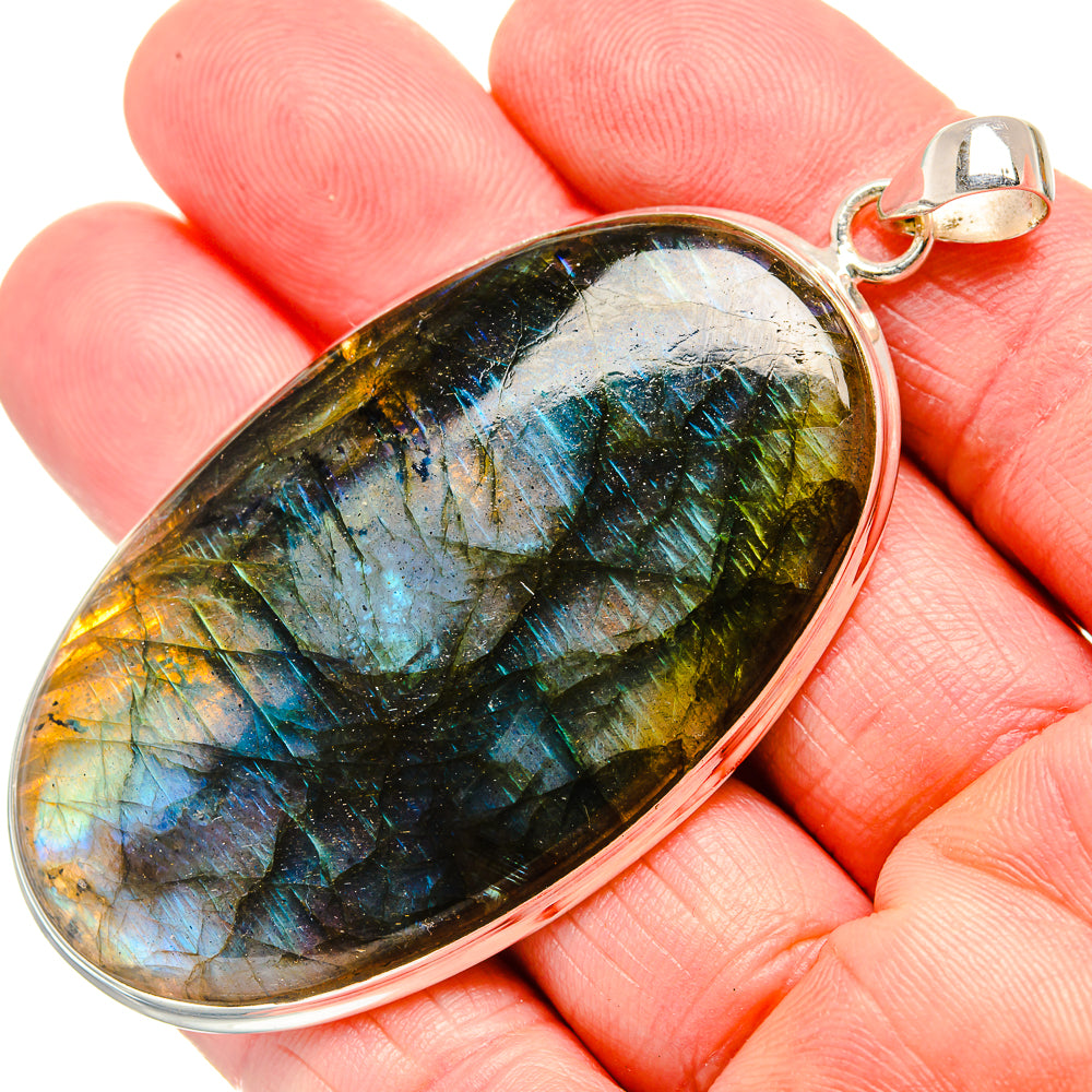 Labradorite pendant on silver bail, oval cabochon with blue, green, gold tones
