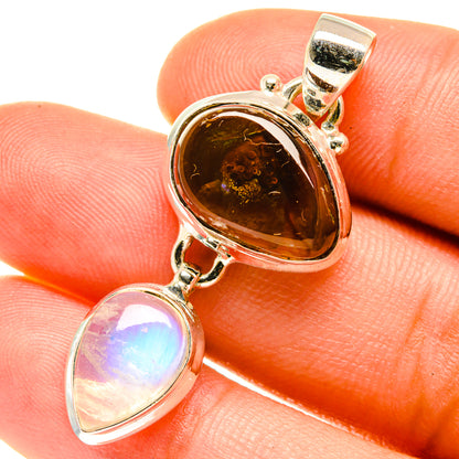 Sterling silver pendant close-up with glowing amber fire agate and iridescent moonstone