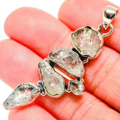 Rough aquamarine pendant close-up with five silver bezel-set crystal pieces