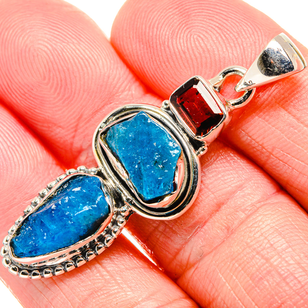 Close-up rough blue fluorite cabochon with red garnet accent on 925 sterling silver pendant