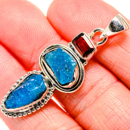 Close-up rough blue fluorite cabochon with red garnet accent on 925 sterling silver pendant