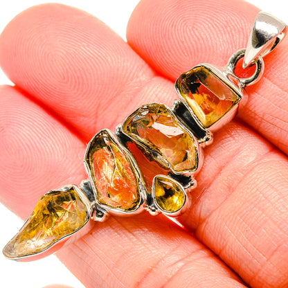 Close-up rough citrine pendant with sterling silver settings and amber gemstone bail