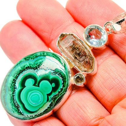 Oval malachite gemstone pendant with blue topaz and clear herkimer diamond in silver setting