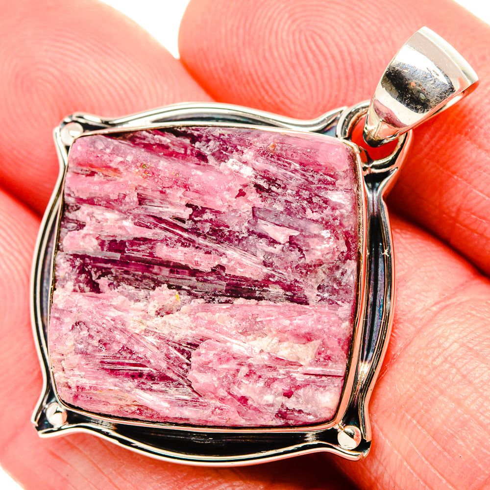 Rough pink tourmaline pendant with silver bail and square bezel in close-up