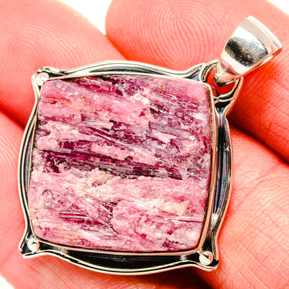 Rough pink tourmaline pendant with silver bail and square bezel in close-up