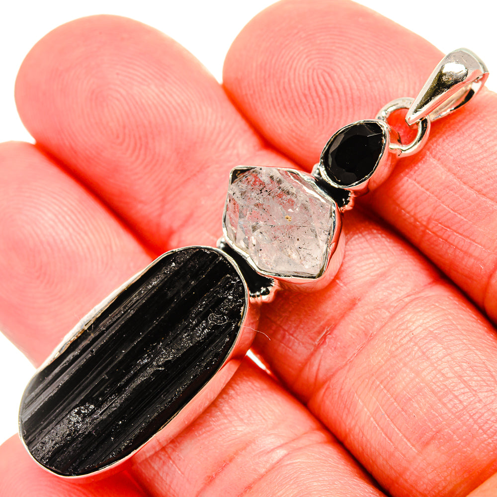 Sterling silver pendant: oval black onyx, rough clear crystal, small round black stone